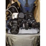 A collection of various cameras, lenses and photography equipment including Minolta 7000 camera,