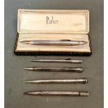 A collection of 4 hallmarked silver pencils and one other.