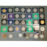 A box of assorted coins, mainly commemorative crowns in cases.