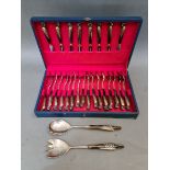 A vintage flatware set of 26 horn handled spoons, forks and salad mixers, handles depicting a