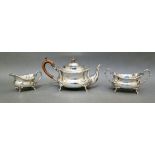 A trio of hallmarked silver tea set comprising of a "boat" teapot, a twin handled sugar bowl and a