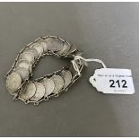 A silver 3d coin bracelet.