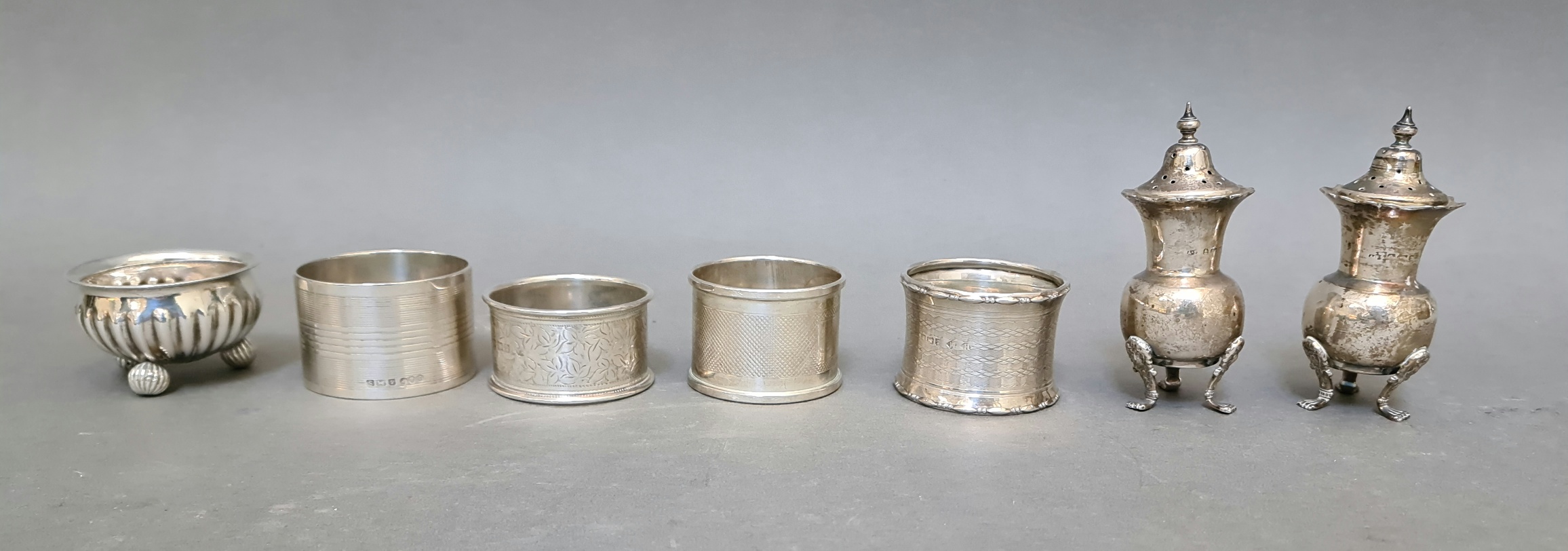 A pair of hallmarked silver pepper and salt pots, a white metal small bowl and four various