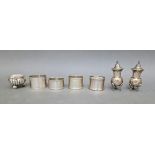 A pair of hallmarked silver pepper and salt pots, a white metal small bowl and four various