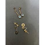 A pair of 9ct gold earrings with topaz stones and a pair of 9ct yellow and white gold drop earrings.