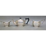 A trio of hallmarked silver tea set comprising of a teapot, twin handled sugar bowl and milk jug,
