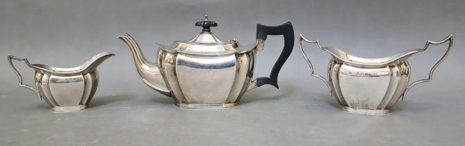 A trio of hallmarked silver tea set comprising of a teapot, twin handled sugar bowl and milk jug,