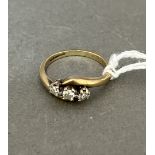 A 9ct gold three stone diamond ring.