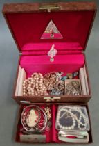 A musical jewellery box containing a variety of costume jewellery to include silver, a string of