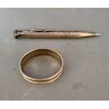 A hallmarked silver pencil, marked 800 and a silver napkin ring.