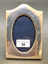 A hallmarked silver and velour backed photo frame, T K C, Birmingham, 1999 with millennium mark.