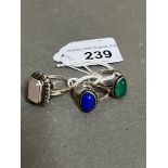 A group of three rings marked 'Silver', one set with a chrysoprase cabochon, another a blue