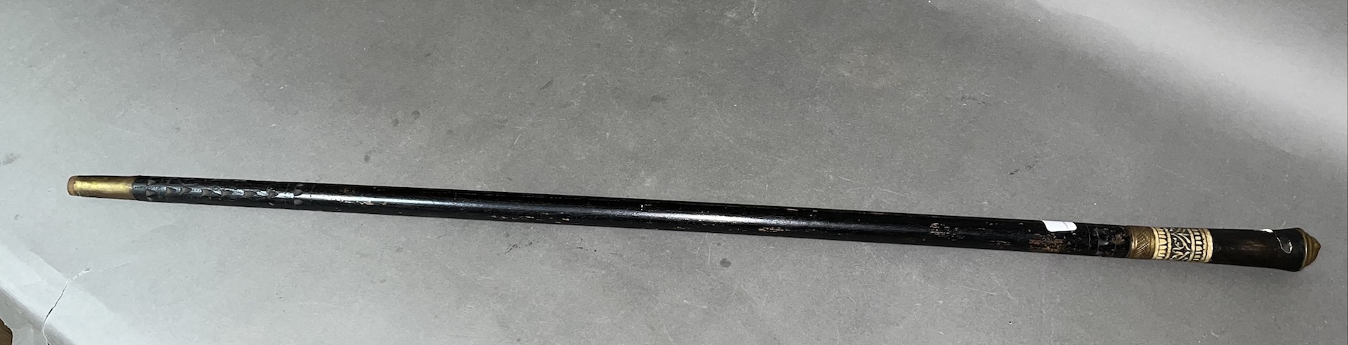 An Indian brass mounted and ebonised sword stick, bone collar, circa 1900, length 90.5cm.