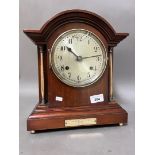 A mahogany cased mantel clock with brass columns, on ball feet, with pendulum, no key.