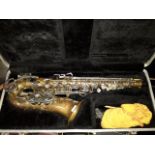 A Selmer Bundy alto saxophone with hard case.