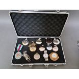 An aluminium case containing various pocket watches, etc.