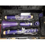 A Virtuosi purple clarinet with hard case.