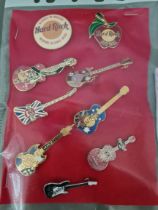 A collection of Hard Rock Cafe badges; Edinburgh, New York, Manchester, San Francisco (limited