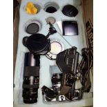 An Olympus OM10 with five lenses and accessories.