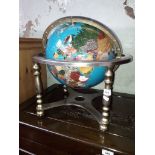A terrestrial globe inlaid with various semi-precious stones, height 46cm.
