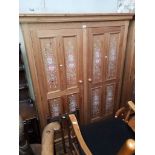 A pine double wardrobe with stencilled flower design.