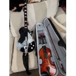 A modern Gear4Music violin and a game's console guitar controller.