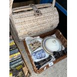 A wicker basket containing ceramics and two metal vases, together with a wicker picnic basket.