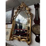 An ornate gilt frame mirror.