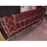 A vintage Eastern wool carpet, red ground, 195cm x 142cm (approx).