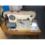 A vintage Jones electric sewing machine with pedal, etc in original case.