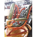 A green leather Chesterfield rocking chair with matching footstool.