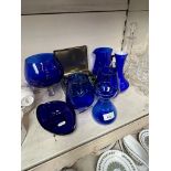 Blue glass items and a tin containing a large quantity of glass beads