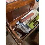 A piano stool with a number of recorders and some sheet music