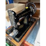 A hand cranked cased Singer Sewing machine, (no key to the case)
