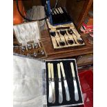 Two boxed sets of plated butter knives and 2 boxed sets of plated spoons