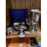 A collection of EPNS ware to include tea pot, a large goblet, a cup, etc and a silver candlestick