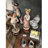 A Capo di Monte figure, two other similar figures, a Coalport figure Visiting Day, and The Masters