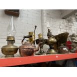 Quantity of copper and brass items including lamps, coal bucket, kettle and watering can.