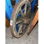 A vintage small wooden cart wheel.