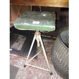 An industrial adjustable metal workshop stool.