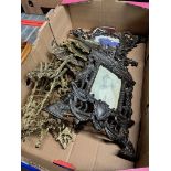 A box of ornate folding metal picture frames