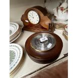 An Edwardian inlaid mahogany mantle clock and a barometer.