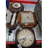 A 1930s oak cased barometer, a late 19th century barometer and a wall clock.