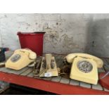 Three vintage twist dial telephones including one budgie phone.