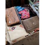 A box of scarves, shawls and clutch bags