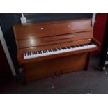 A Chappell teak cased upright piano.