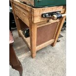 A woodworking bench with vice and with drawers containing various tools to include planes,