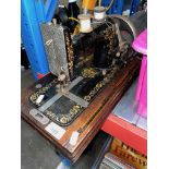 A vintage handcrank Verity sewing machine.