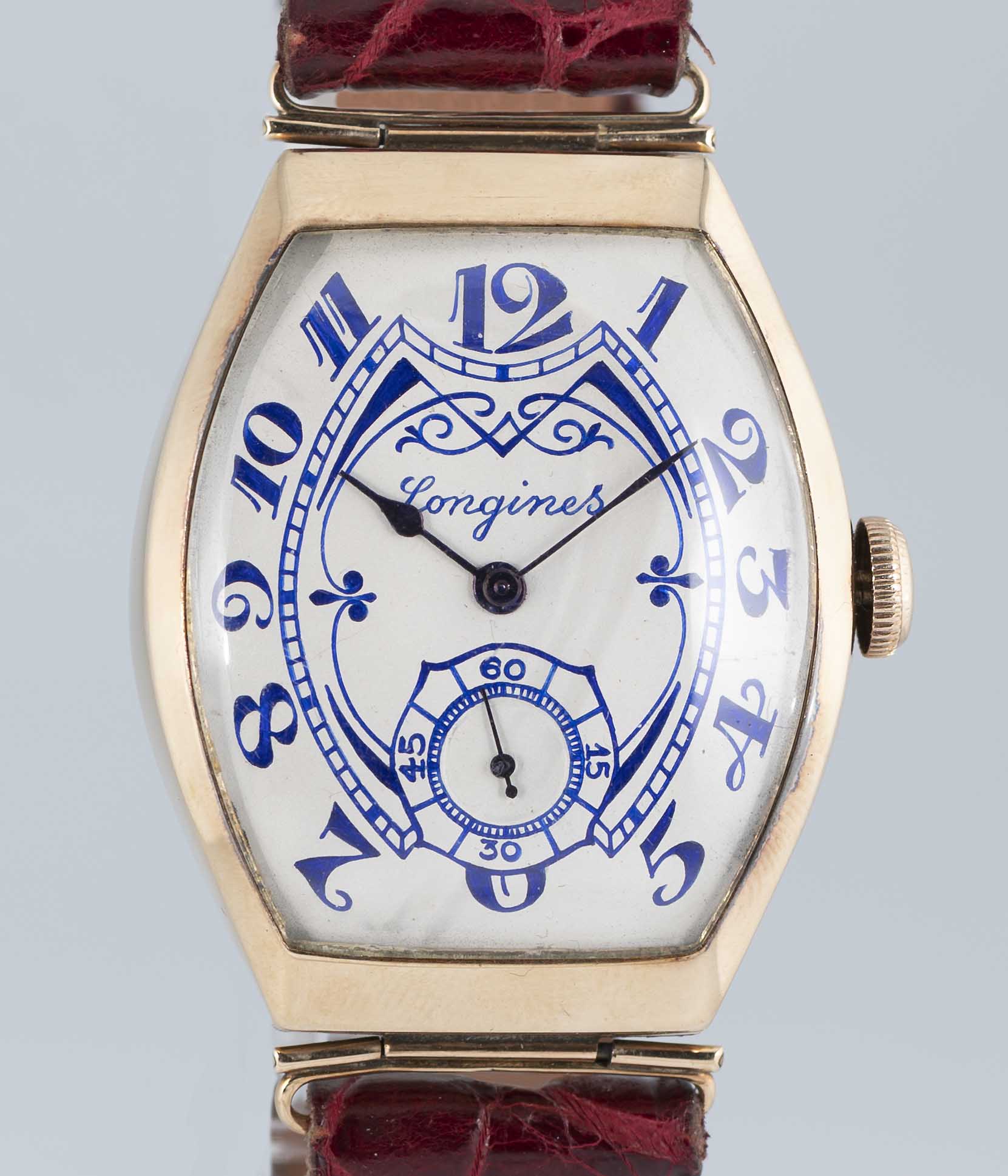 A VERY RARE GENTLEMAN'S 14K SOLID ROSE GOLD LARGE TONNEAU CASED LONGINES WRIST WATCH DATED 1915,