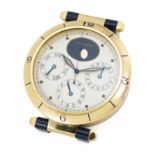 A CARTIER PASHA TRIPLE CALENDAR MOONPHASE DESK CLOCK CIRCA 1980s Movement: Quartz. Case: Diameter